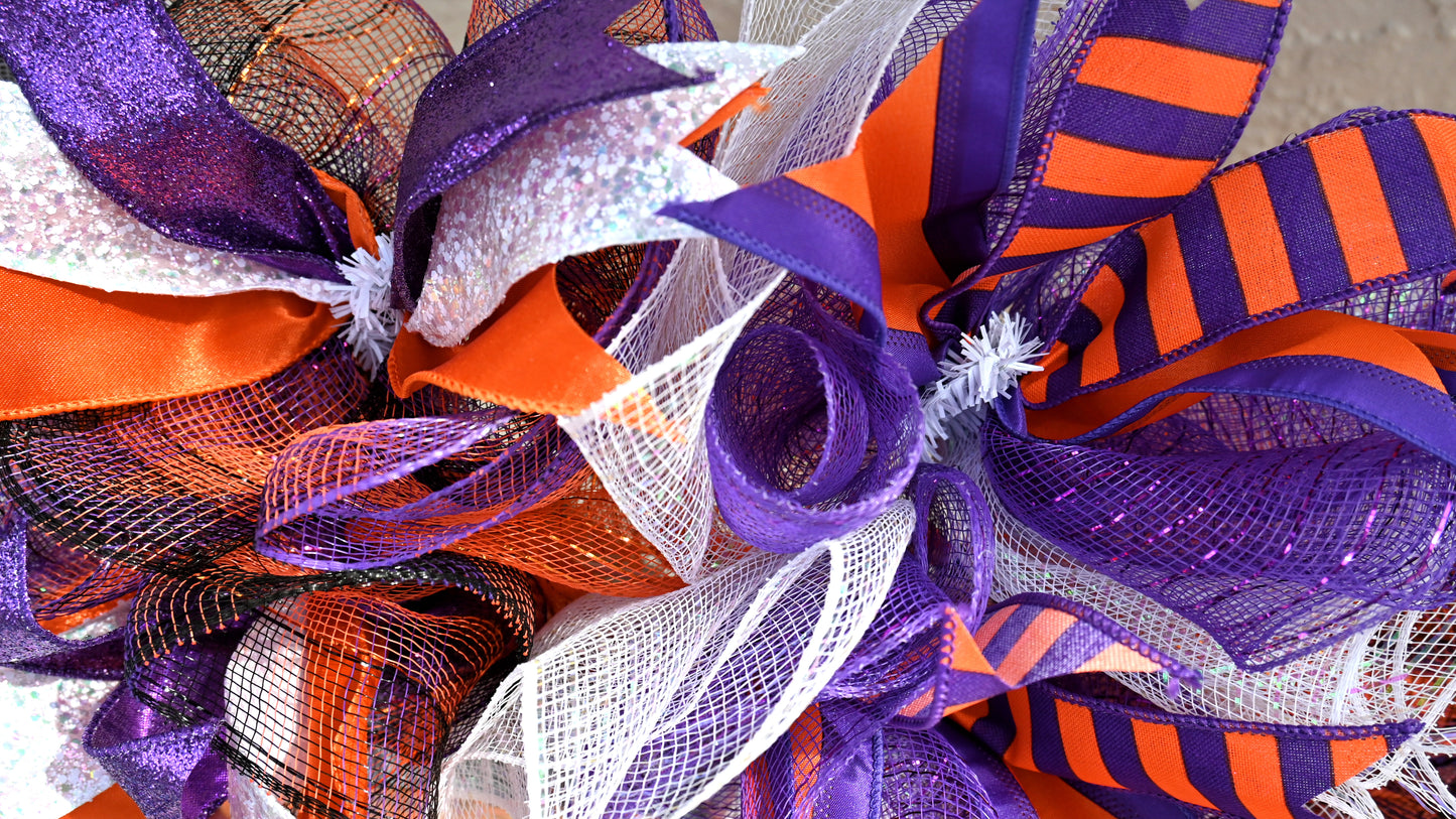 a close up of a purple and orange wreath