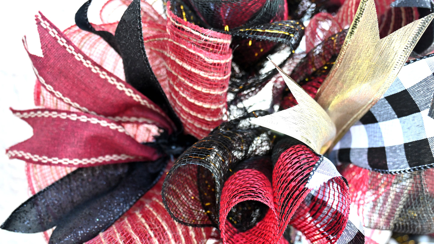 a close up of a red and black wreath