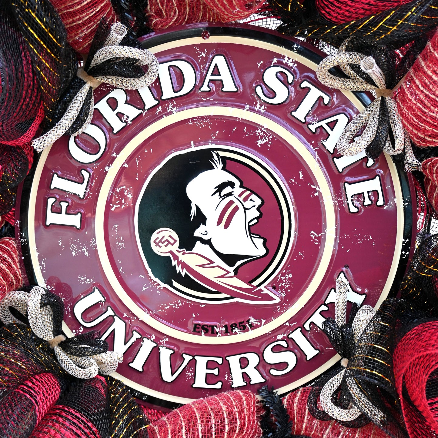 a florida state university sign is surrounded by red and black yarn