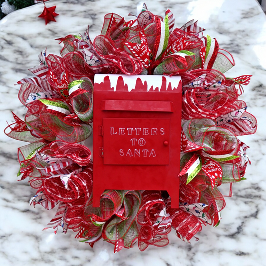 a christmas wreath with a red mailbox on it