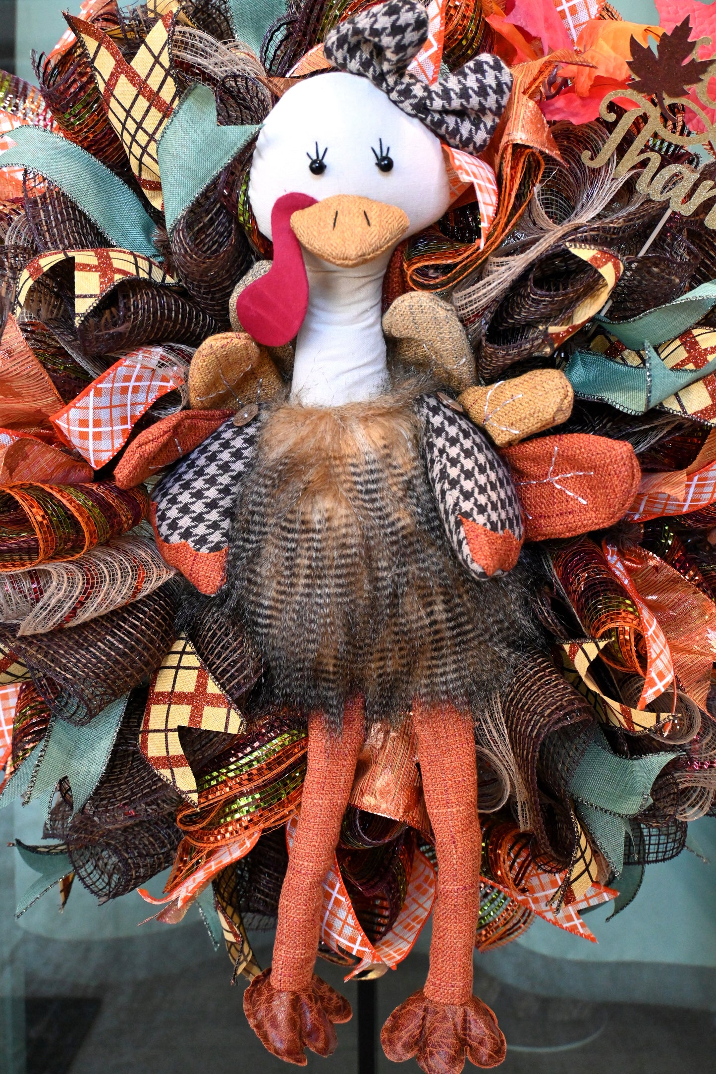 a wreath with a chicken on top of it