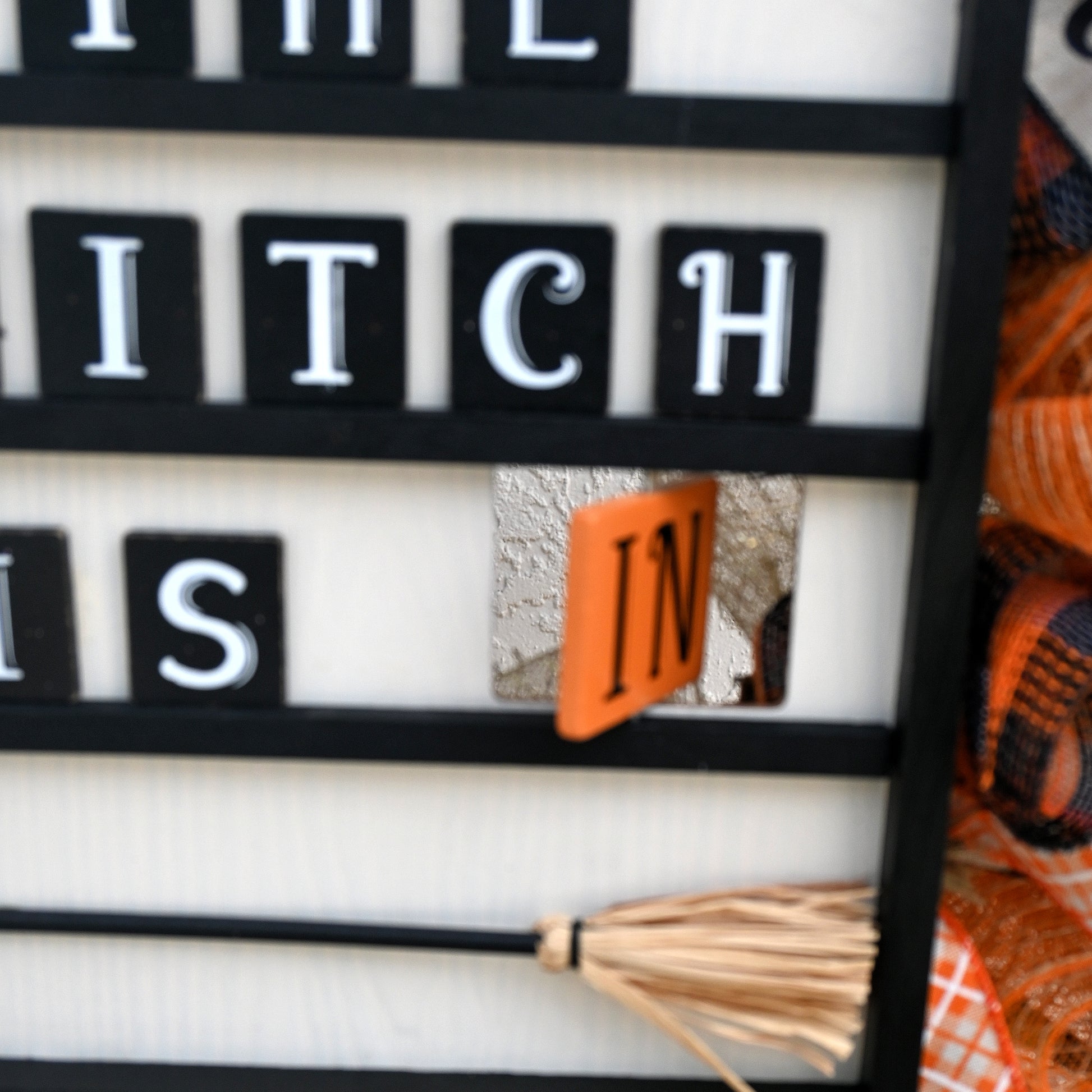 a close up of a sign with a broom