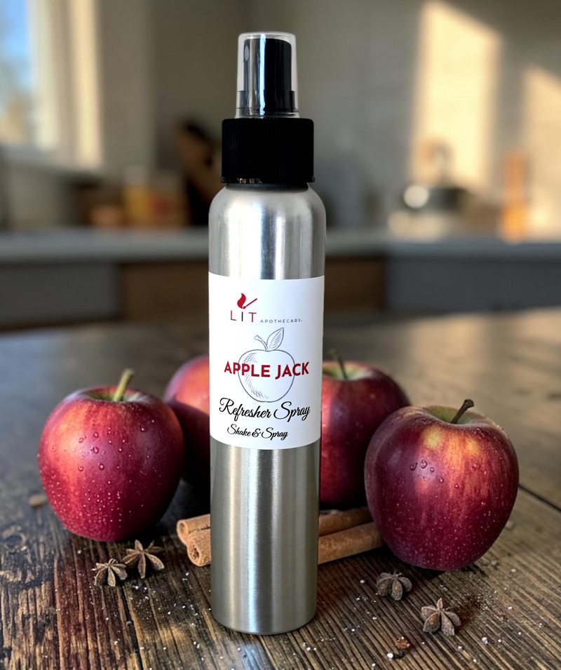 Lit Apothecary Apple Jack room spray displayed with red apples, cinnamon sticks and star anise