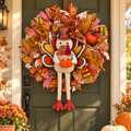 Turkey Thanksgiving wreath with autumn ribbons and dangling legs on an olive front door, styled with pumpkins and mums