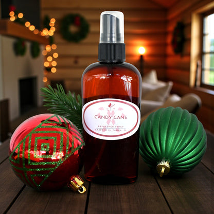 Candy Cane Room Spray bottle displayed with festive holiday ornaments, ideal peppermint air freshener for winter celebrations.