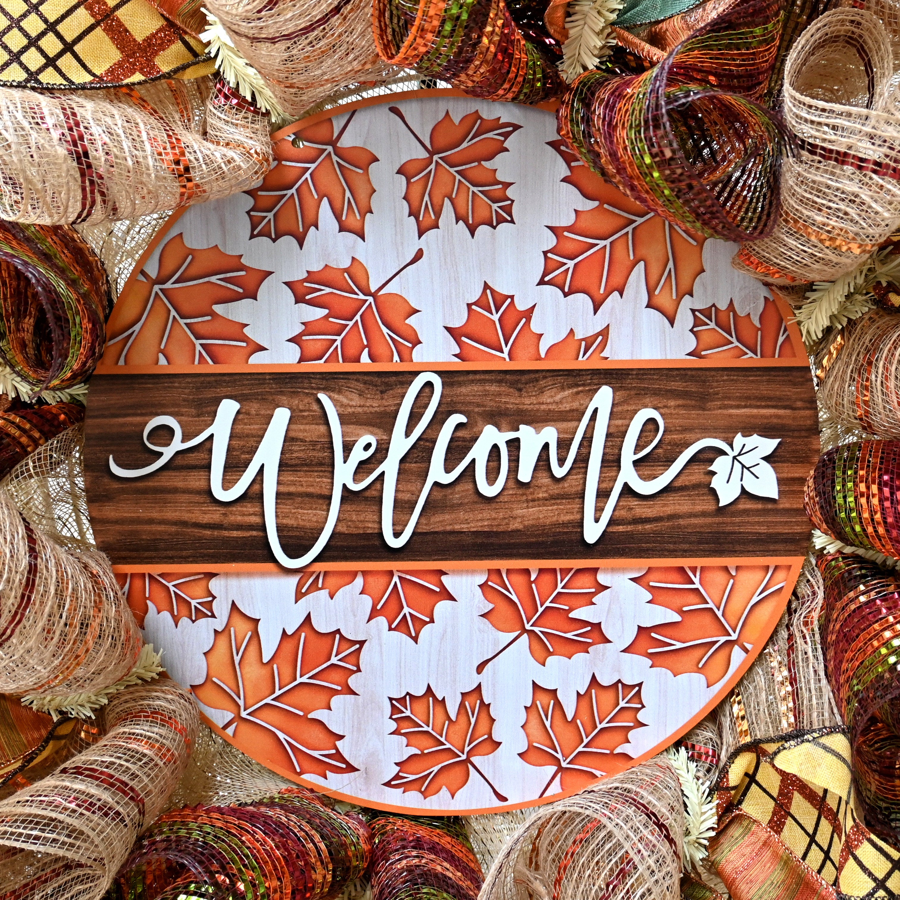 a welcome sign surrounded by fall colored yarn