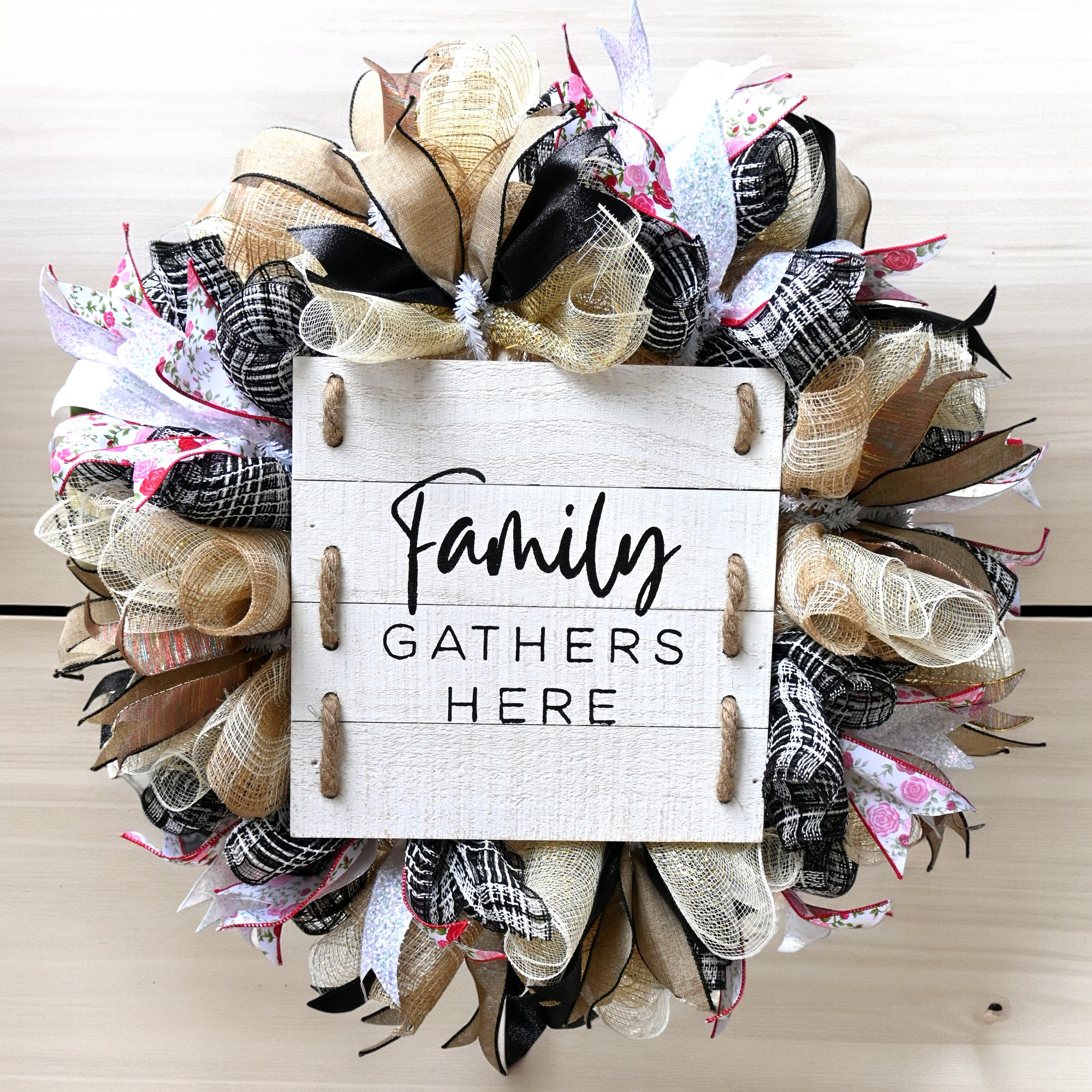 a family gather's here sign hanging on a door