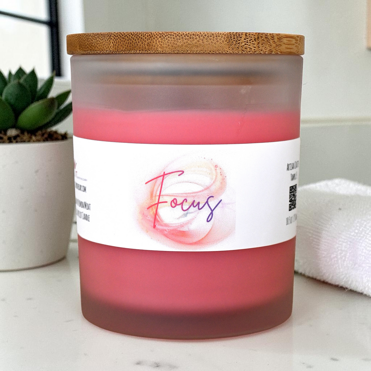 Focus rosemary lemon mint candle in pink frosted glass jar with bamboo lid, 10.5 oz