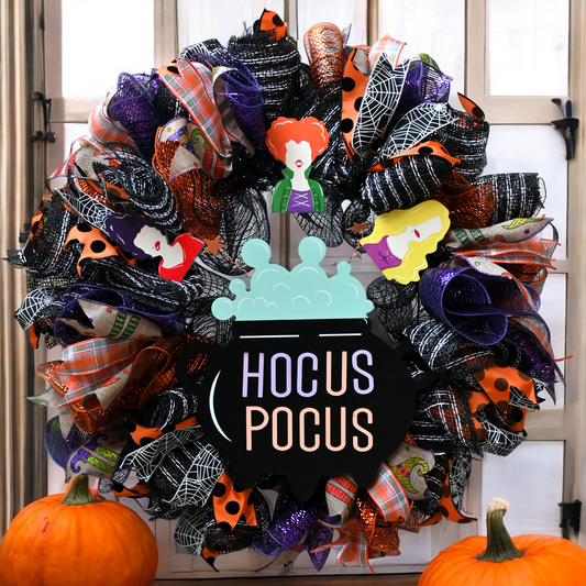 a halloween wreath with a sign that says hocus pocus