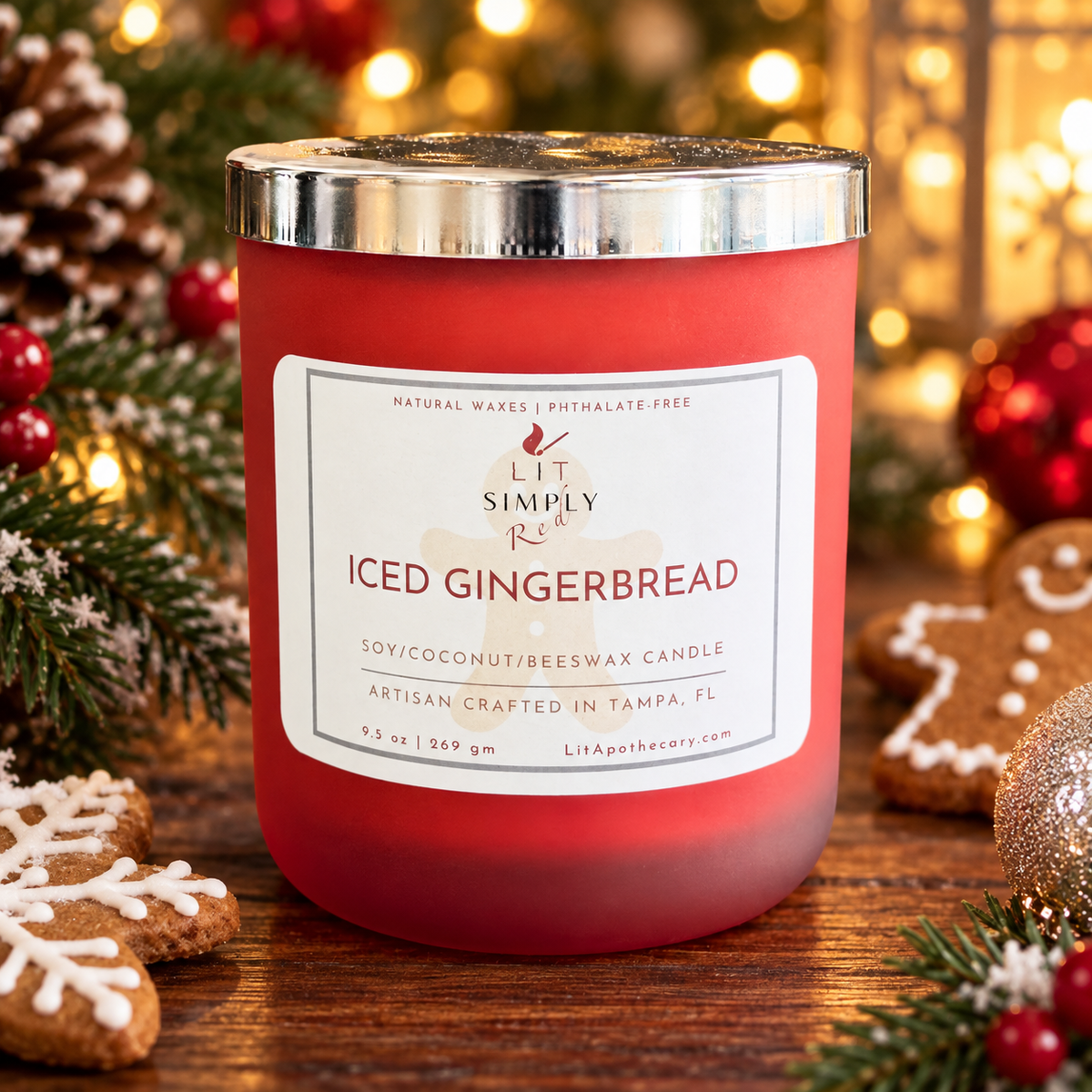 Iced Gingerbread Christmas candle in a red frosted glass jar, styled with gingerbread cookies, evergreen sprigs, ornaments, and warm holiday lights.