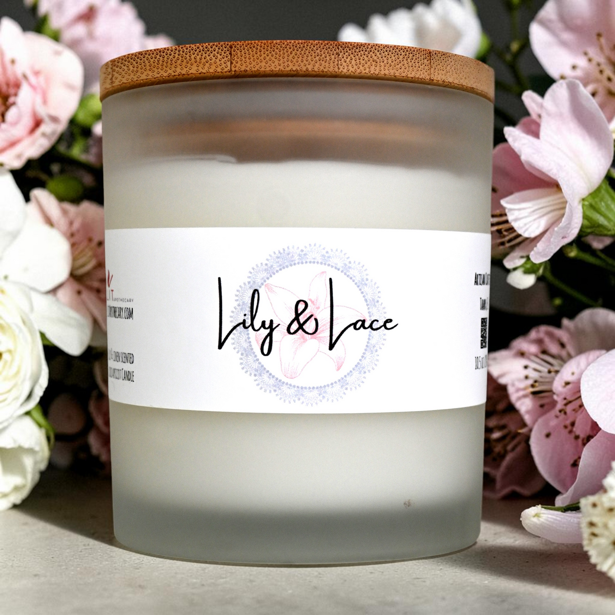 Lit Apothecary Lily & Lace candle with bamboo lid against a floral background