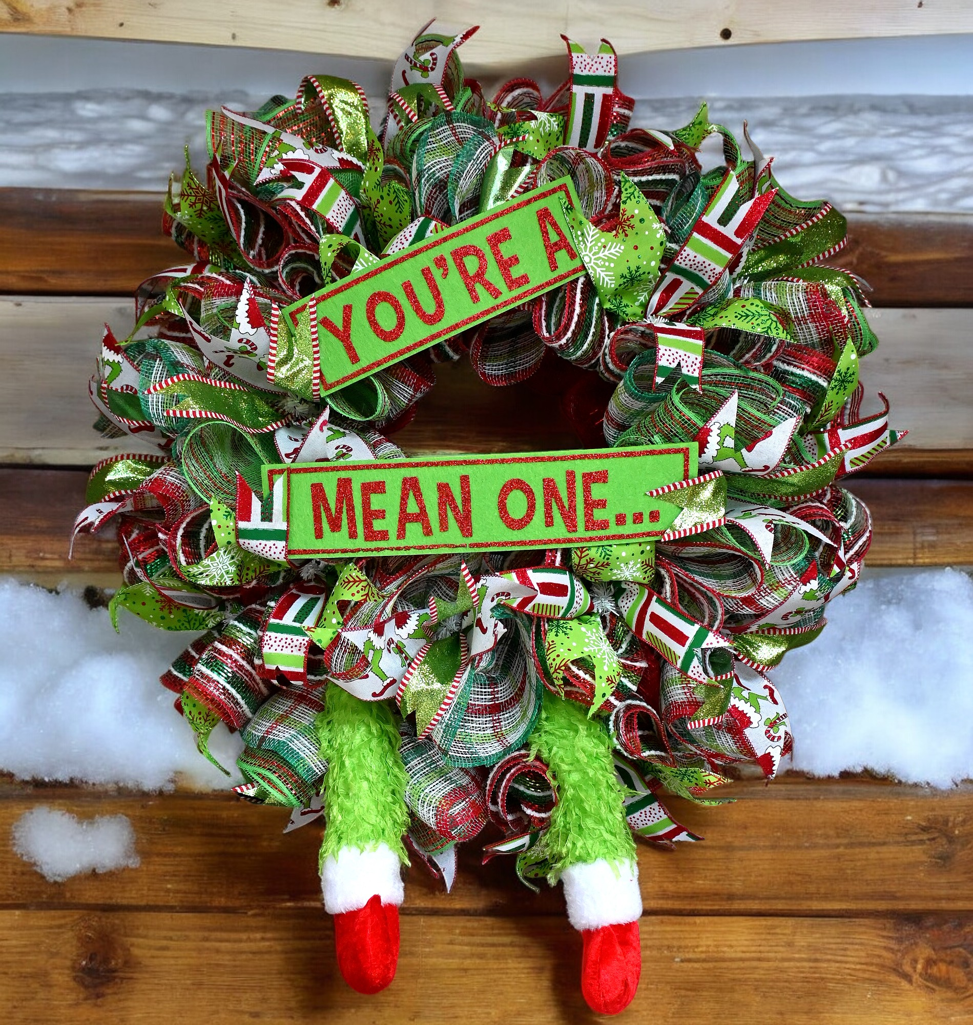 a christmas wreath that says you're a mean one