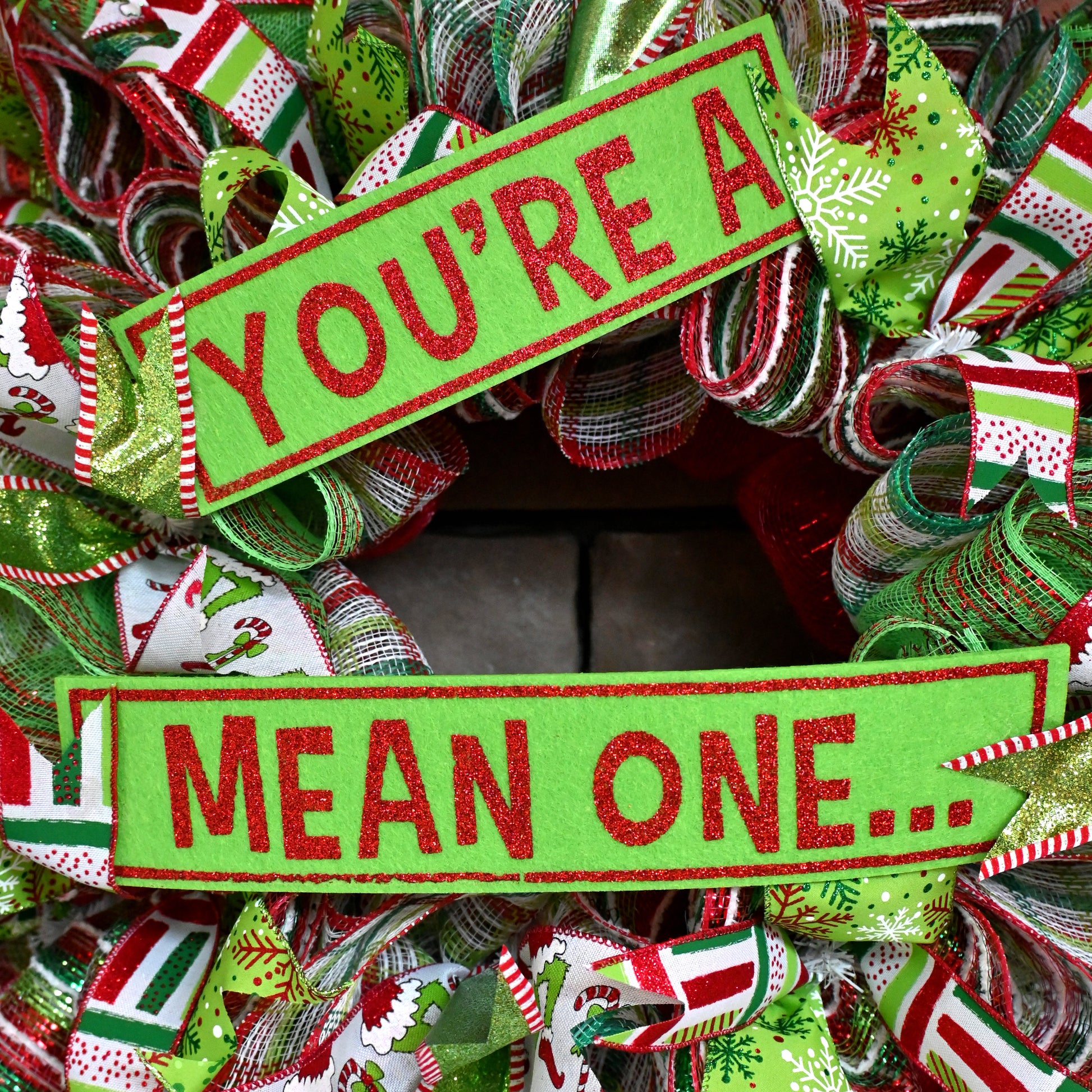 a christmas wreath that says you're mean one