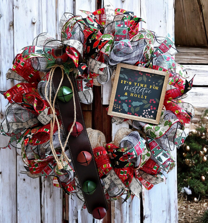 a christmas wreath with a chalkboard sign on it