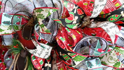 a close up of a christmas wreath with ribbons