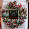 Nice Until Proven Naughty Christmas wreath with red, lime green and white holiday ribbons