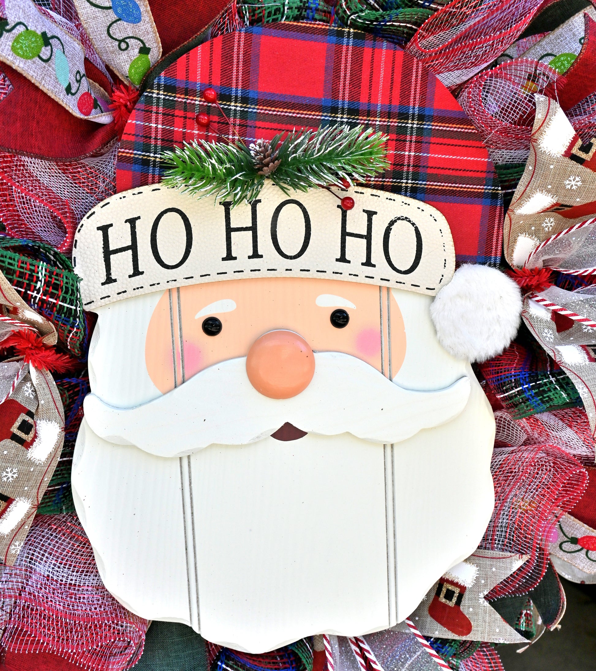 Close-up of the Santa Wreath - Ho Ho Ho Wreath - Christmas Wreath showcasing vibrant ribbons including red/green reversible and holiday lights themes.