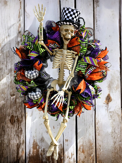 a skeleton wreath is hanging on a wooden wall