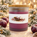 Slay Santa Sleigh Frosted Sugar Plum candle in plum-colored frosted glass with bamboo lid, styled with frosted plums and Christmas greenery.