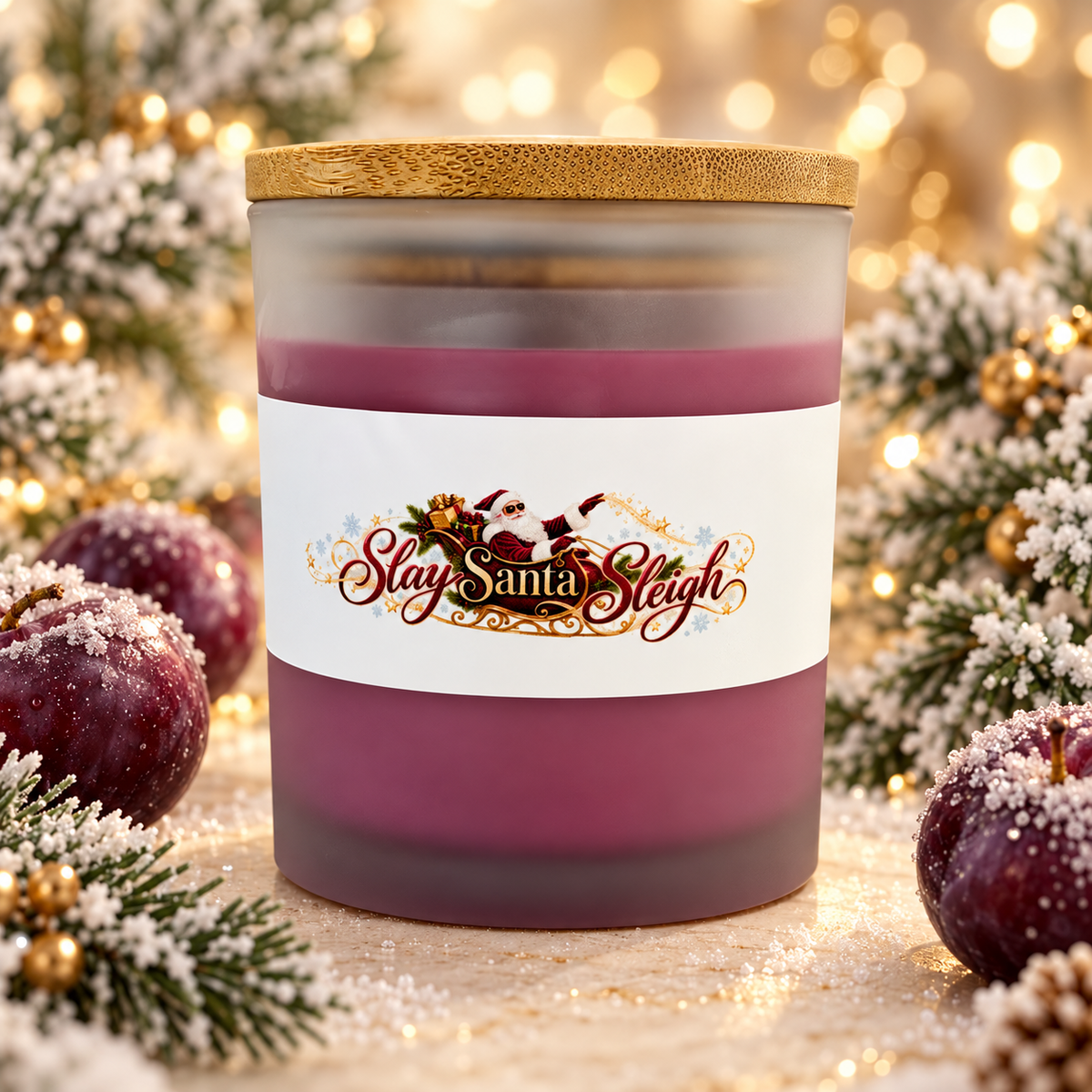 Slay Santa Sleigh Frosted Sugar Plum candle in plum-colored frosted glass with bamboo lid, styled with frosted plums and Christmas greenery.