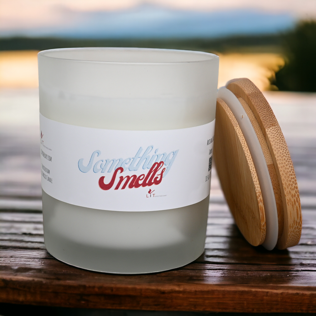 Something Smells cherry blossom candle open with bamboo lid beside frosted glass jar
