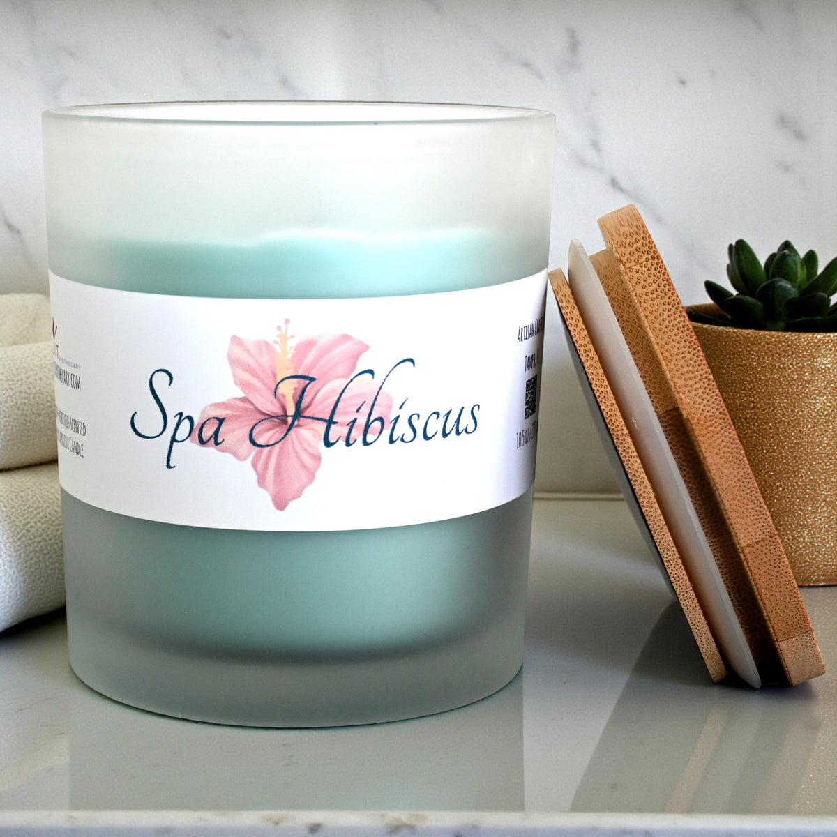 Open Spa Hibiscus candle showing wax inside its frosted glass jar