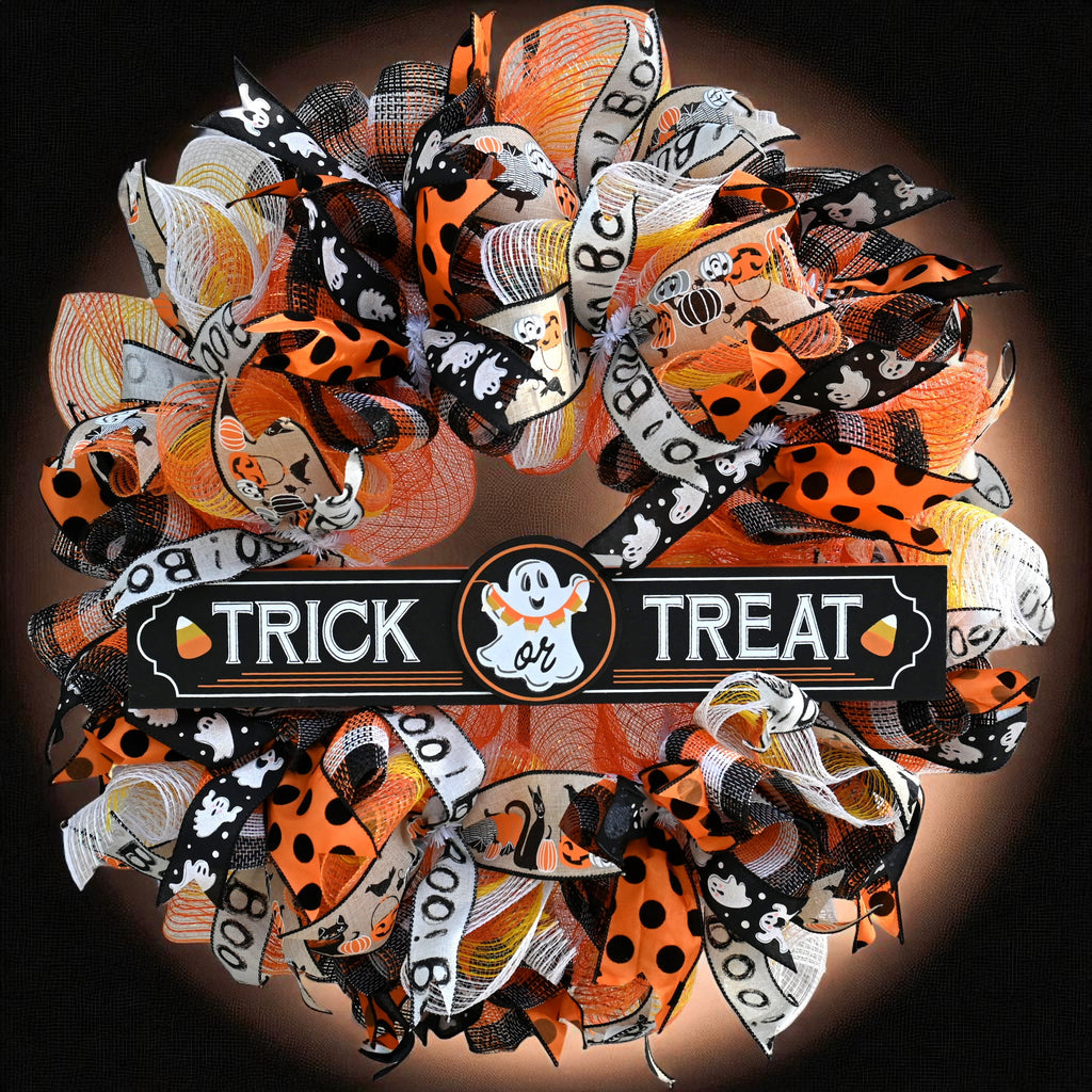 Trick or Treat Halloween wreath with playful ghost sign, orange, black, yellow and white ribbons, and festive front door decor.