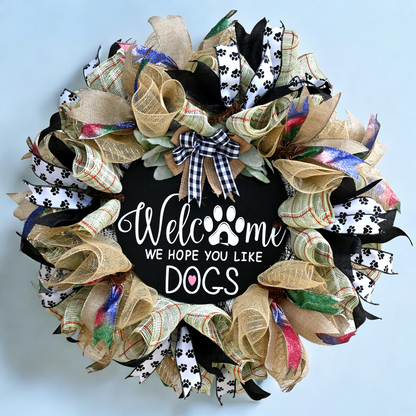 a welcome wreath with a dog's paw on it