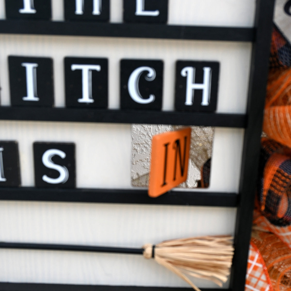 Close-up of reversible Witch Is In and Witch Is Out Halloween wreath sign.