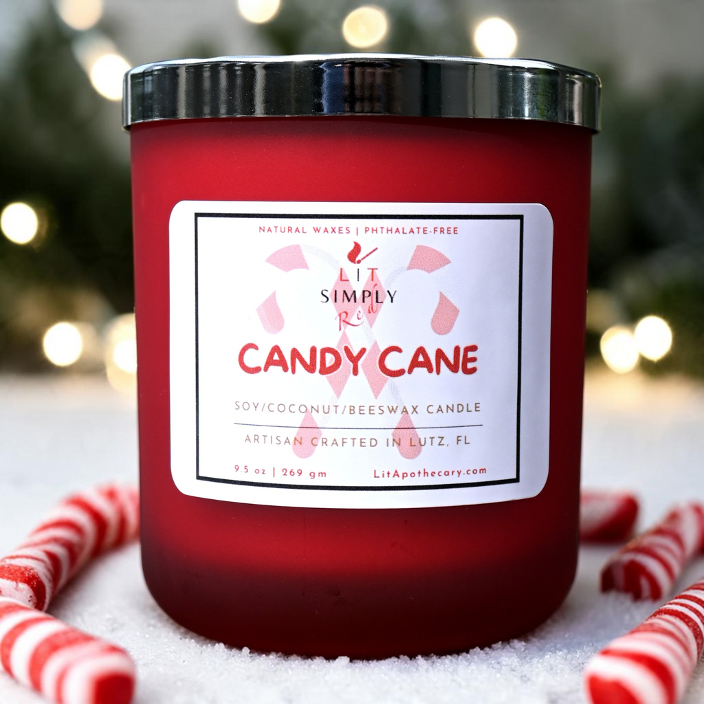 Candy Cane candle in a red frosted glass jar with a silver lid, styled with candy canes and soft holiday lights.