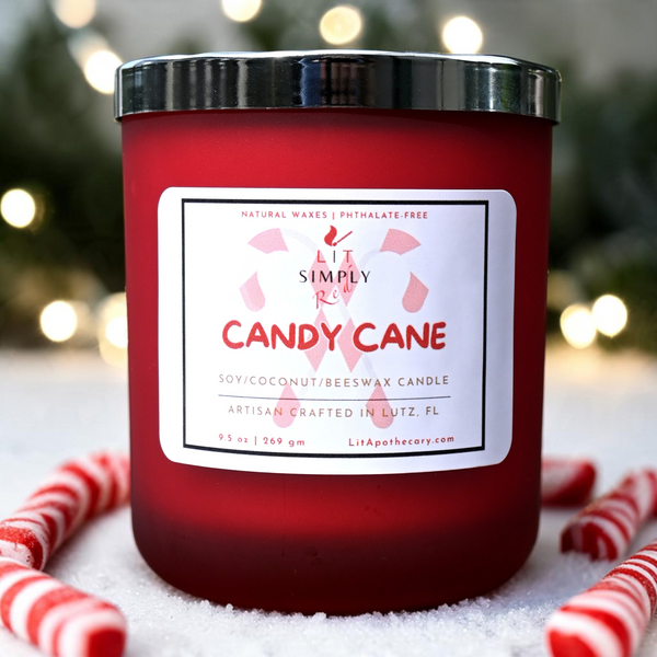 Candy Cane candle in a red frosted glass jar with a silver lid, styled with candy canes and soft holiday lights.