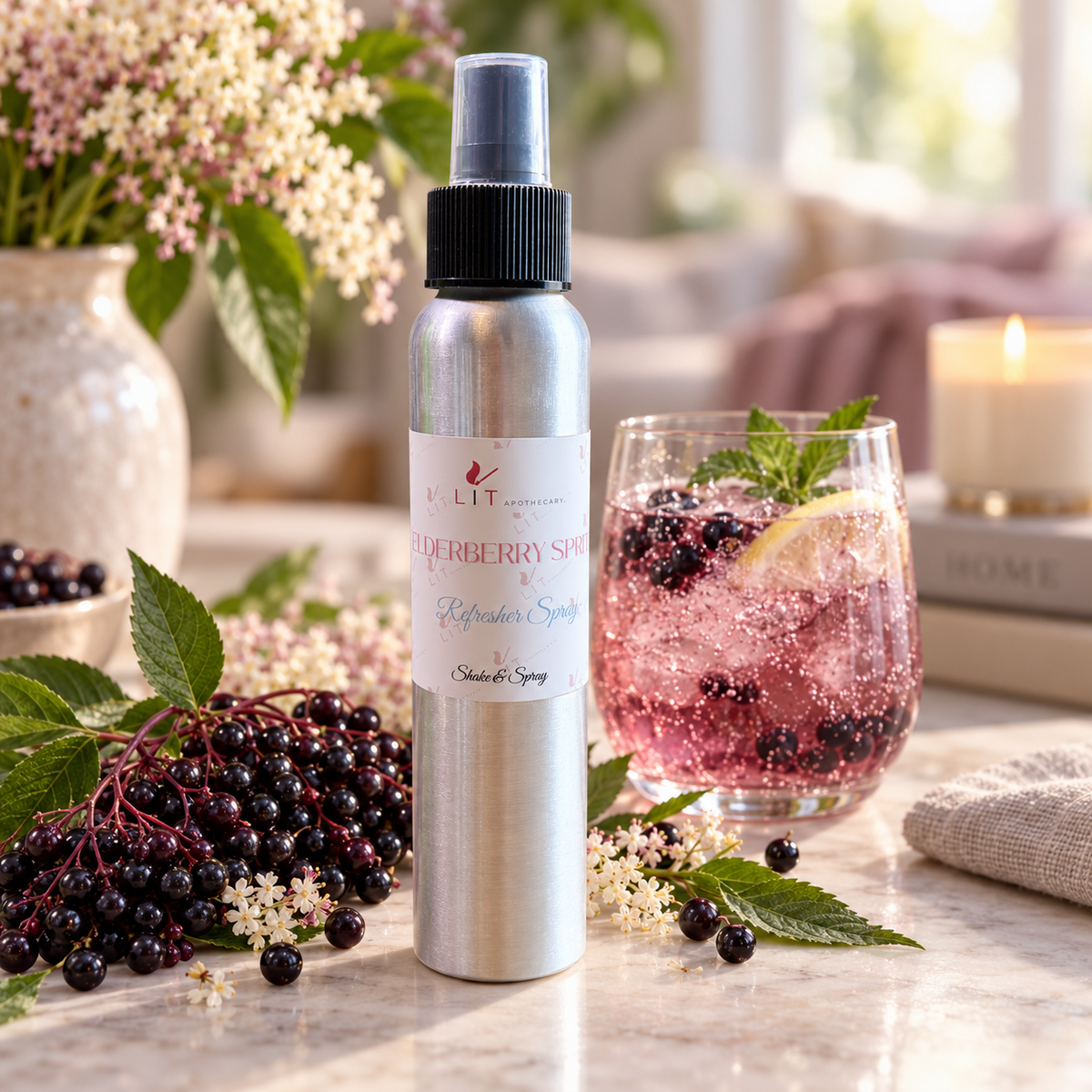 Elderberry Spritz room spray styled with elderberries, flowers, and a sparkling rosé cocktail