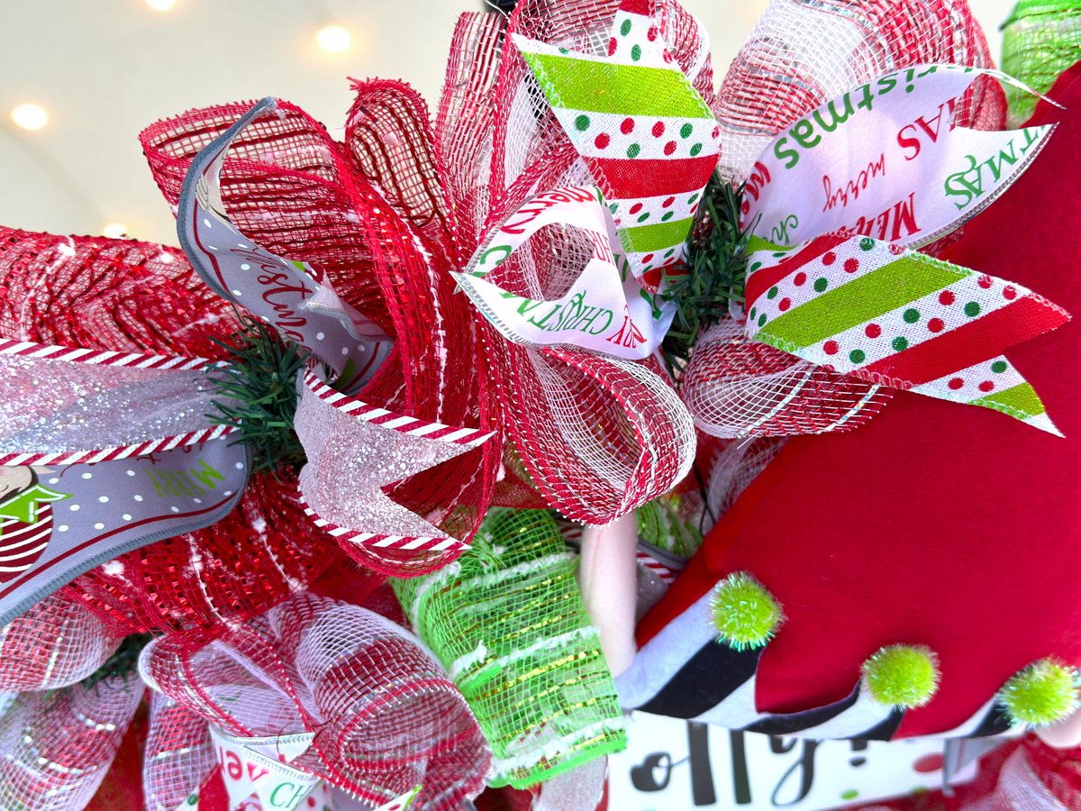 Detail of layered red, white and lime mesh and patterned Christmas ribbons on elf wreath.