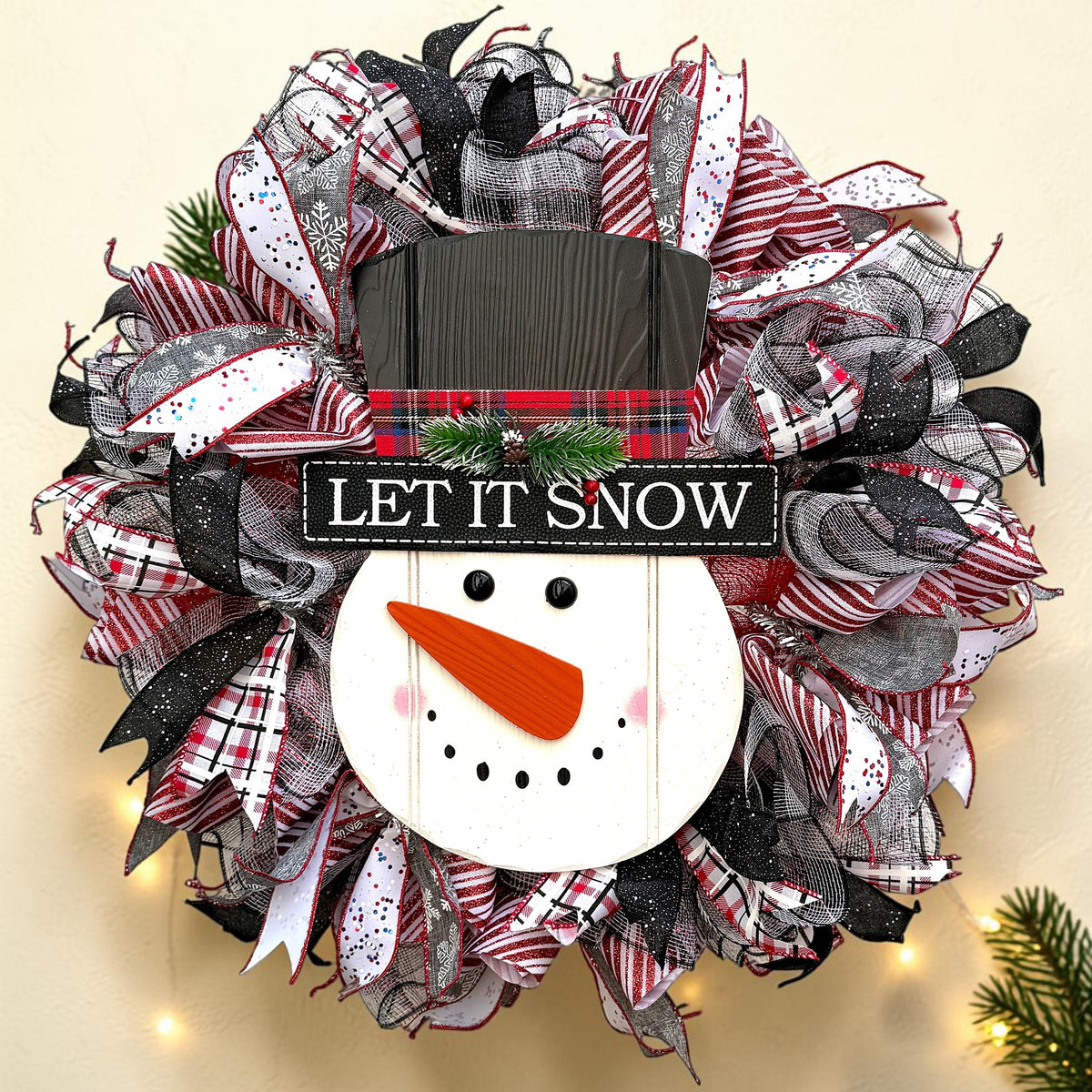 Let It Snow snowman Christmas wreath with red, white and black ribbons and a wooden snowman centerpiece
