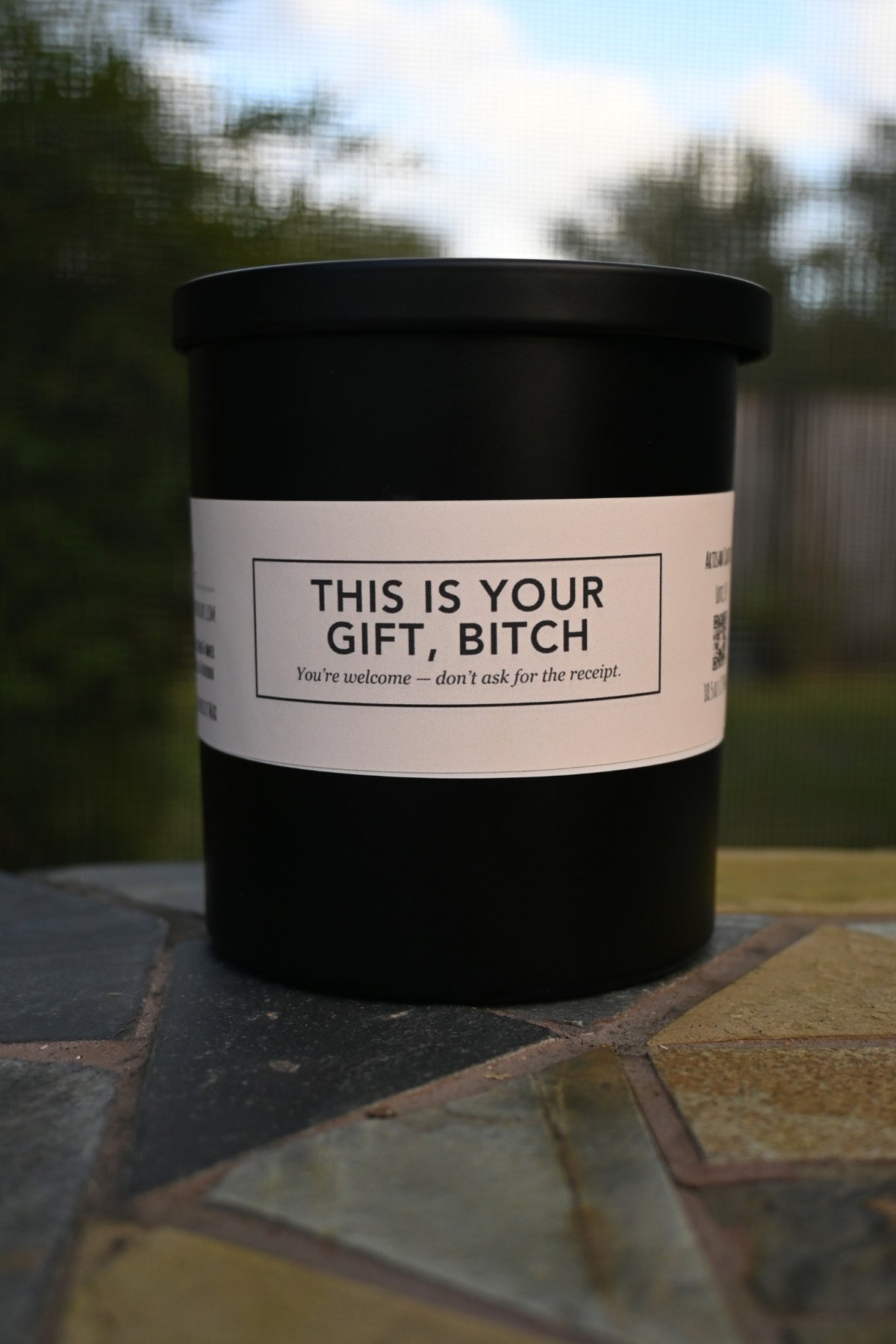 Original unedited photograph of actual matte black candle closed in outdoor setting