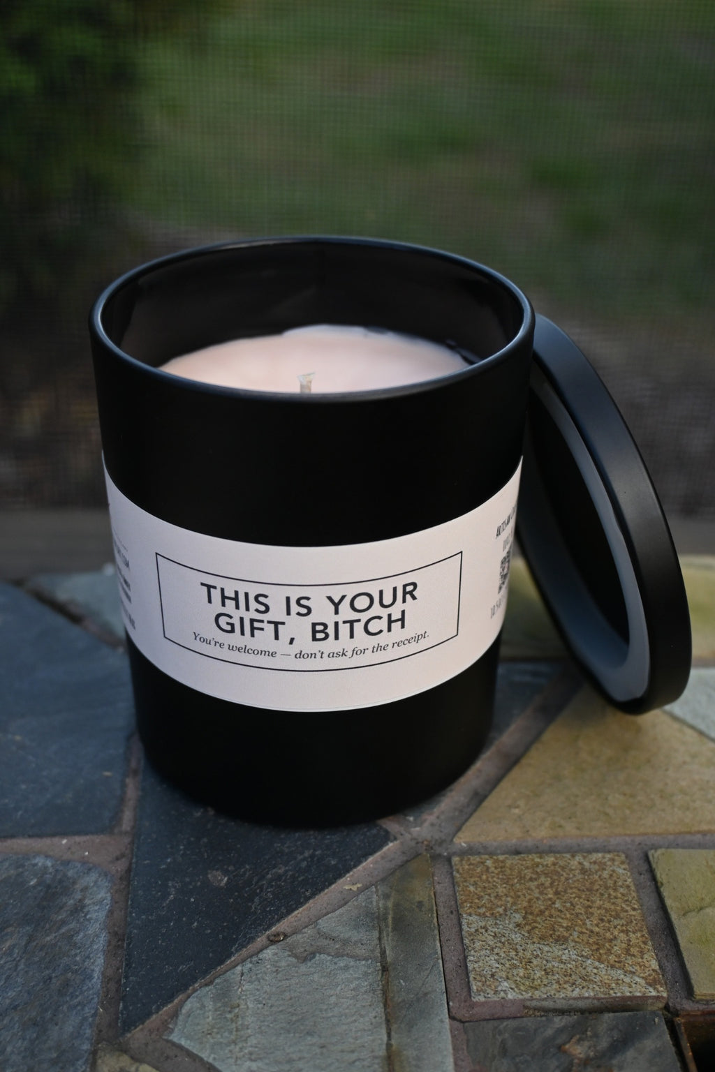 Original unedited photograph of actual matte black candle open showing cream wax