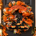 Witch Hat Halloween Wreath with "The Witch Is In" sign and three witch hats on a dark front door