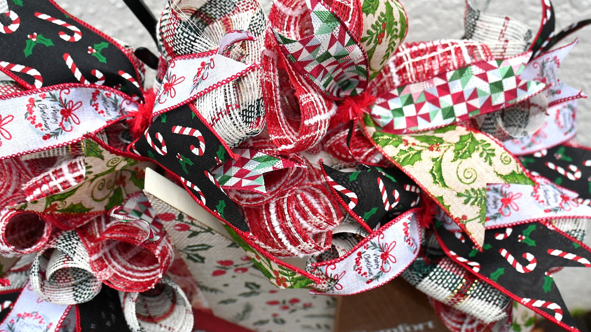 Close-up of holly, berry and festive ribbon accents on the Comfort and Joy wreath