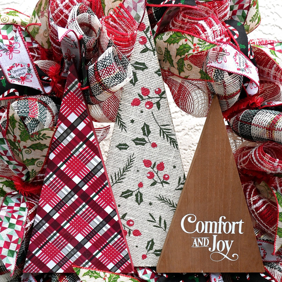 Close-up of the Comfort and Joy wreath sign with three textured Christmas trees