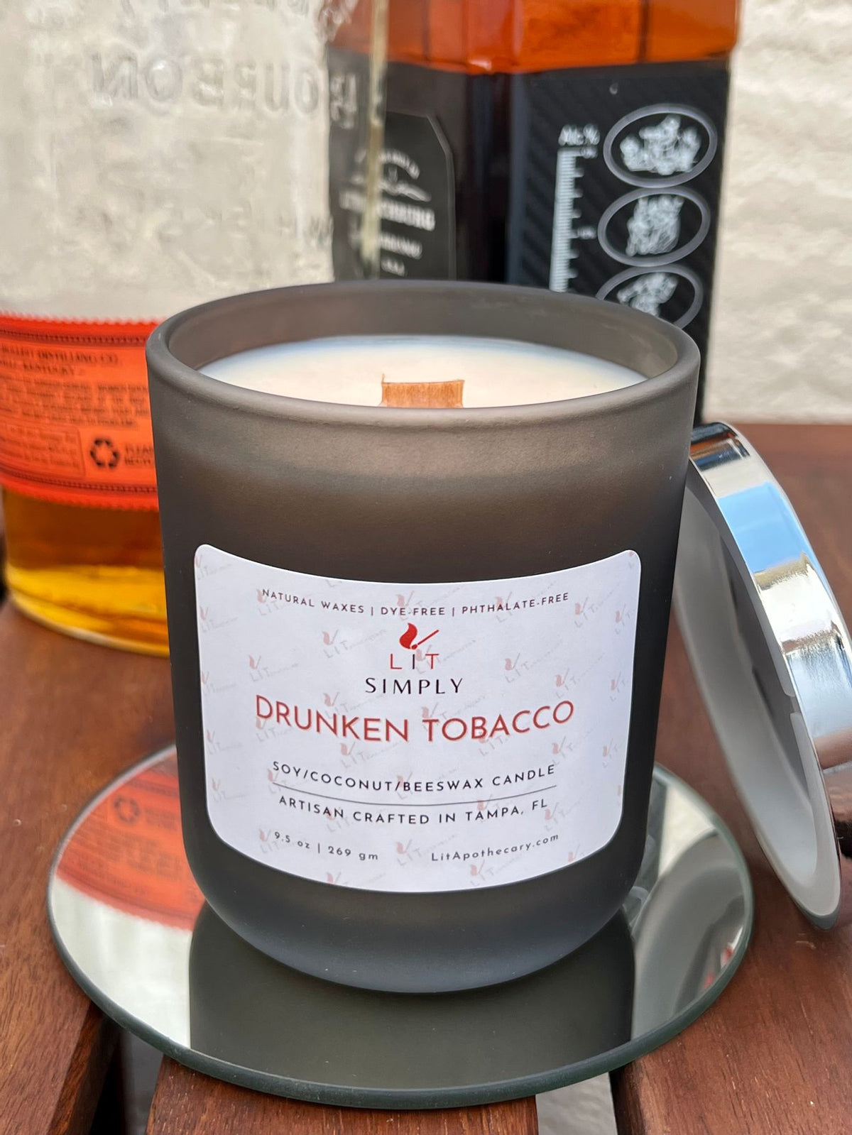 Open Drunken Tobacco candle showing wooden wick and wax in a decorative jar.