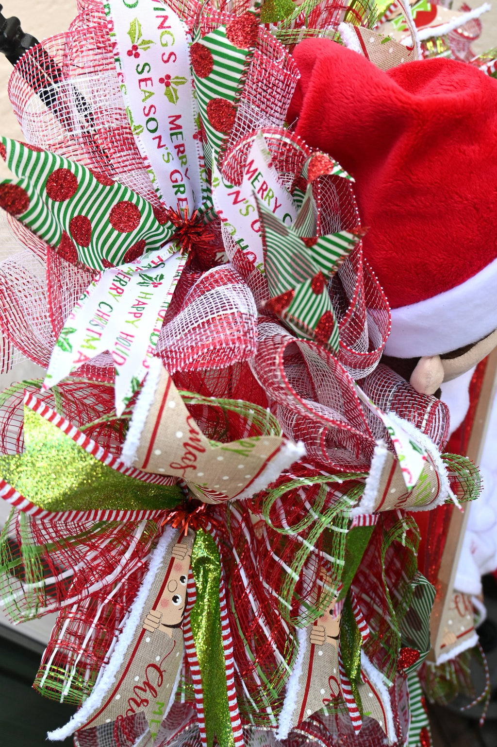 Close-up of coordinating red, green and white ribbons on the elf holiday wreath
