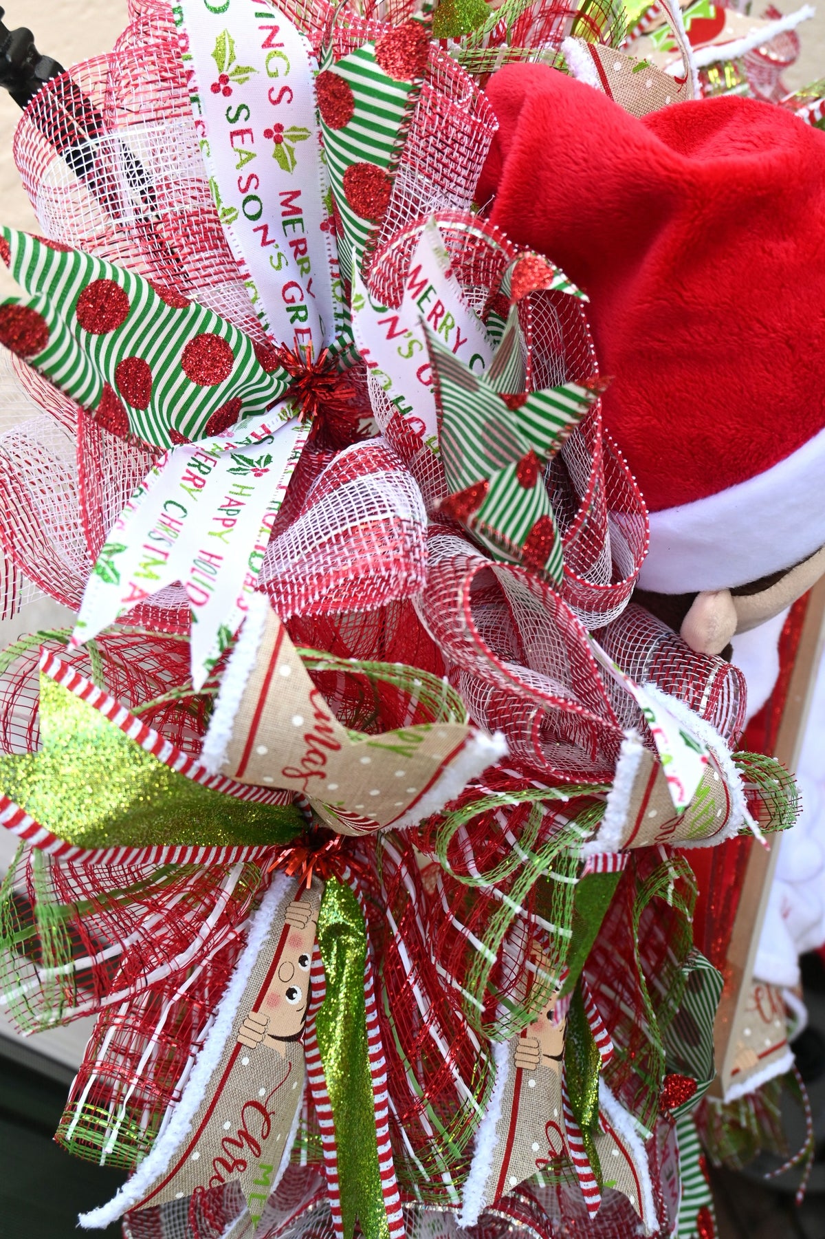 Close-up of coordinating red, green and white ribbons on the elf holiday wreath