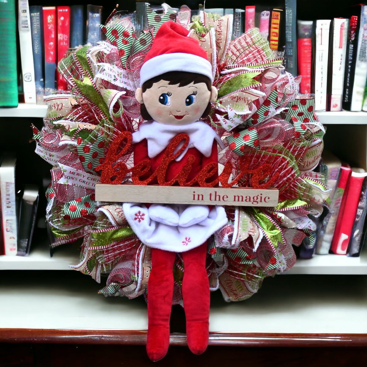 Full view of the festive girl elf decoration used in the Believe Christmas wreath