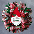 Lighted gnome Christmas countdown wreath with red, lime green and white holiday ribbons