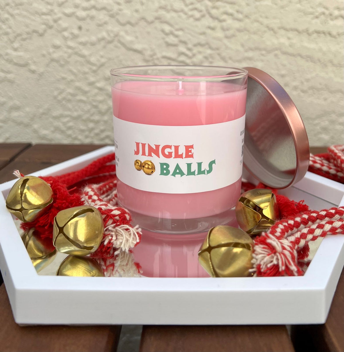 Open Jingle Balls peppermint candy cane Christmas candle showing the festive candle wax and holiday presentation.