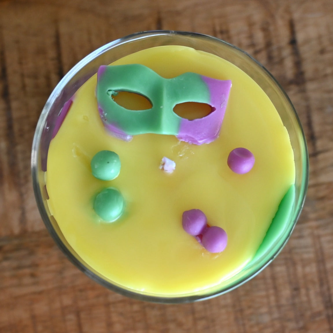Close-up of Mardi Gras King Cake Candle decorated for New Orleans festivities