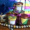 Mardi Gras King Cake Candle with purple, green and gold masquerade mask topper
