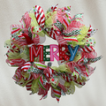 Whimsical Merry Christmas wreath with adjustable Santa hat and red, white and green ribbons