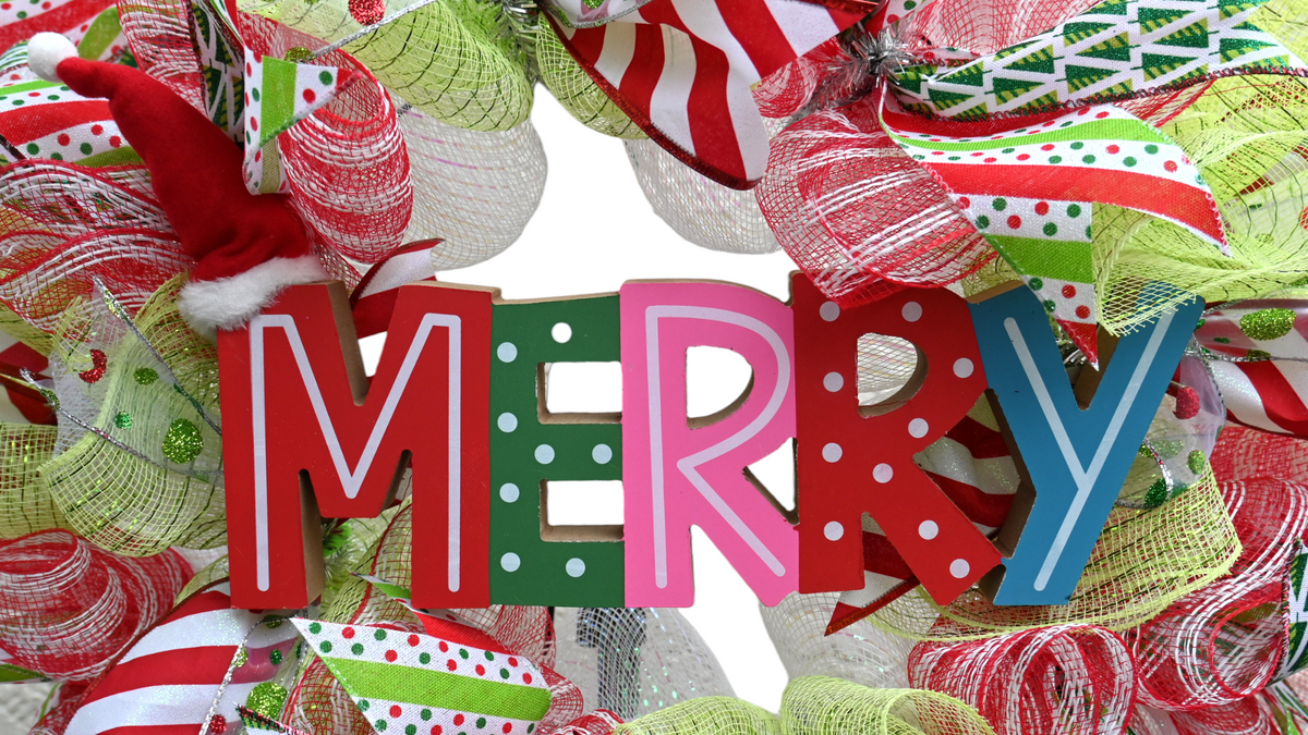 Close-up of the Merry wreath sign with an adjustable Santa hat over the letter M