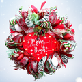Merry and Bright lighted Christmas wreath with colorful bulb ornaments in a snowy holiday setting